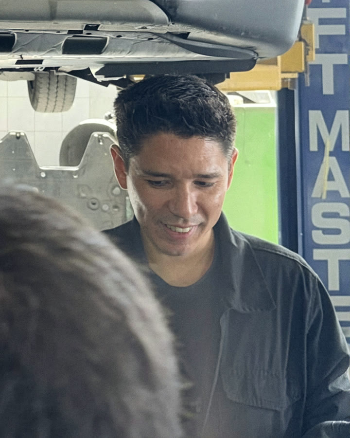Luiz, right-hand man at Senna Auto Service, talking with a customer