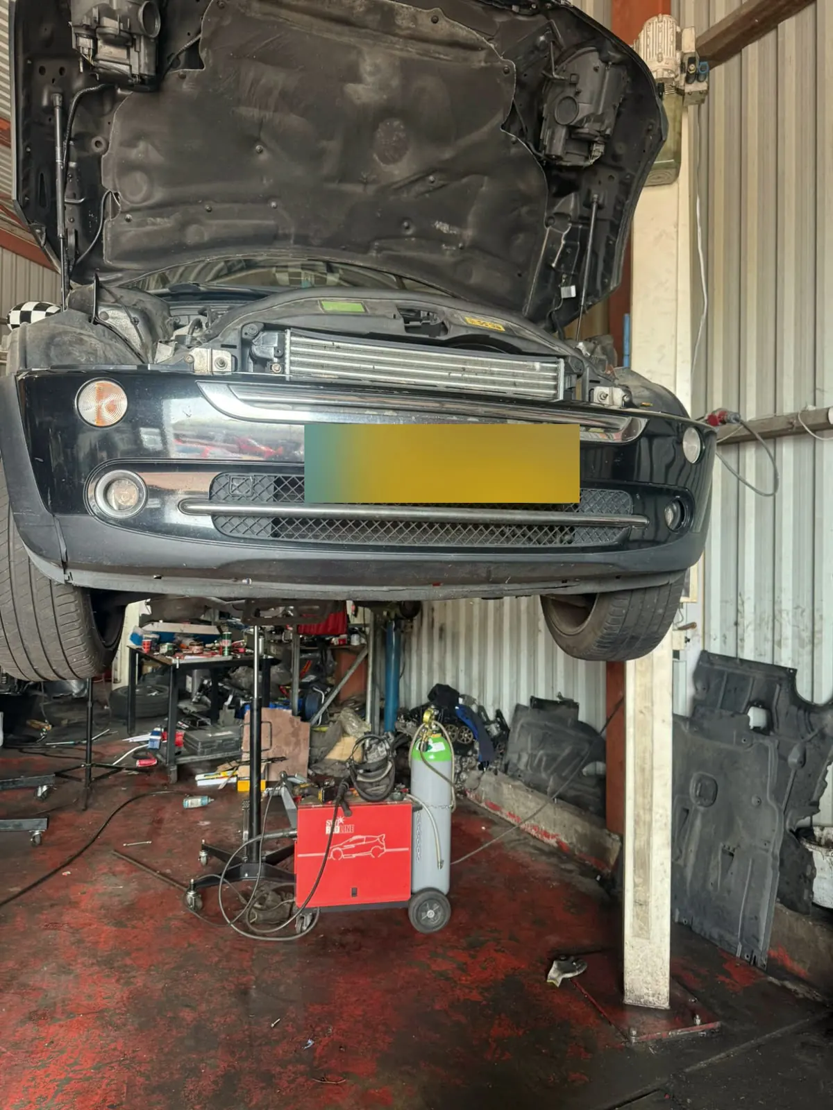 Mini Cooper on the lift for a service at Senna Auto Service